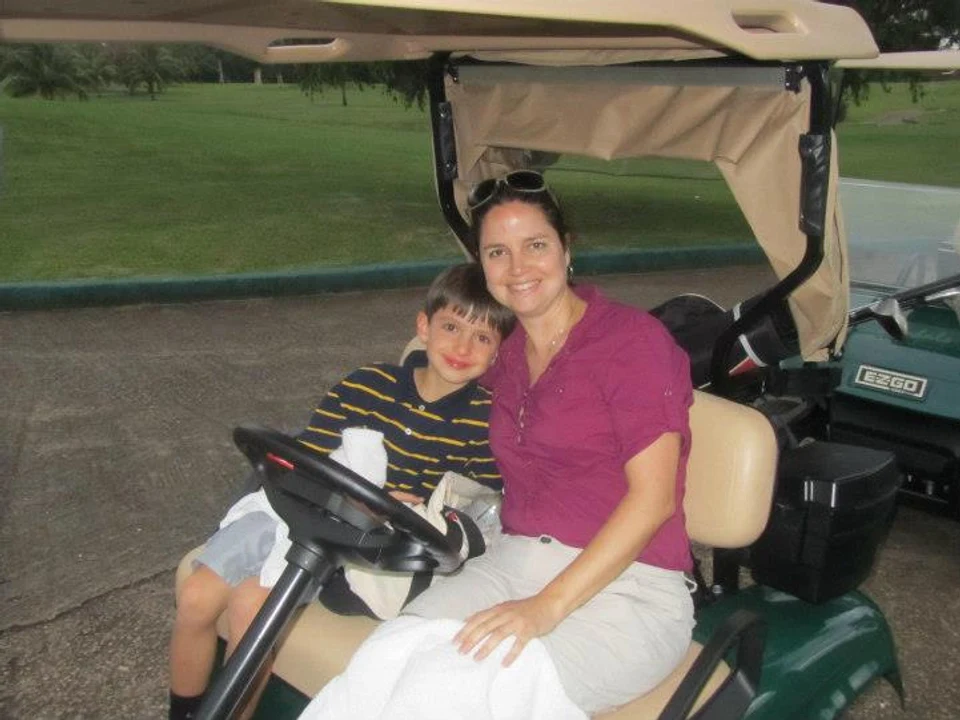 Alex Langone with his mom in a golf cart
